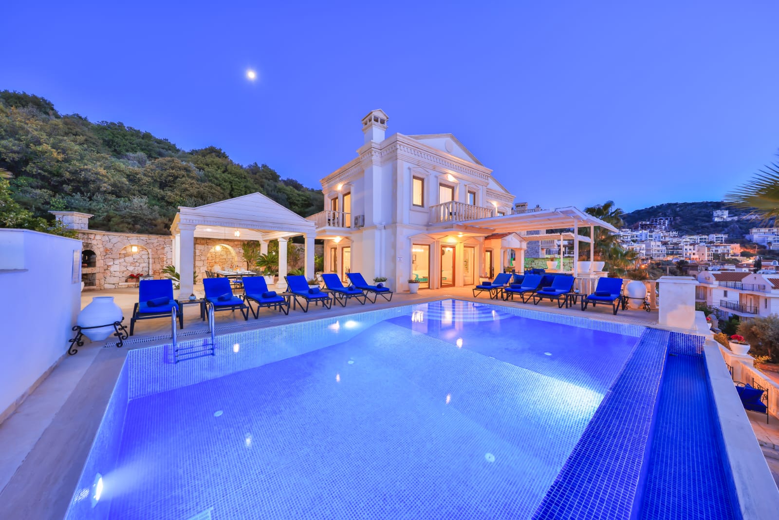 Outdoor pool and sun loungers at night in Villa Palmiye, villa holidays in Kalkan, Turkey