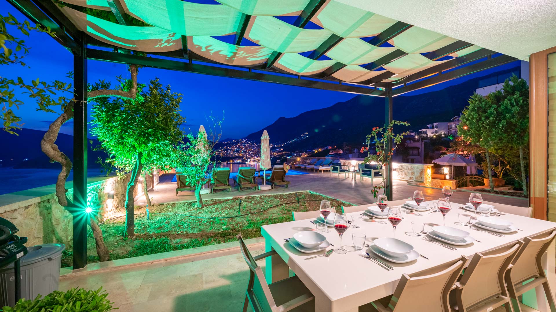 Outdoor dining table at night in Villa Elia, villa holidays in Kalkan, Turkey