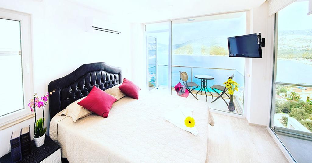 Double bedroom and balcony in Mahumet Salvarli Suites, villa holidays in Kalkan, Turkey