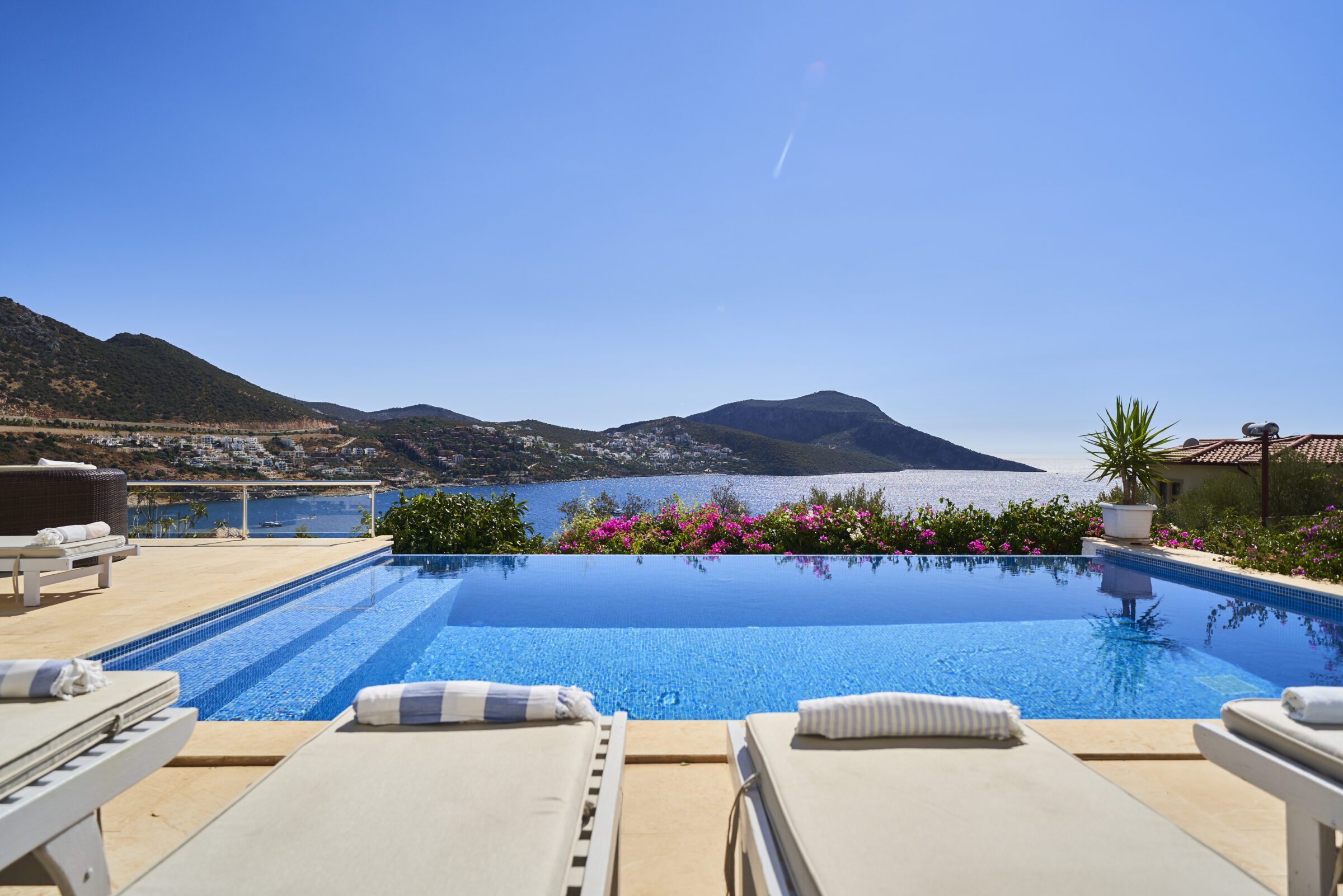 Outdoor infinity pool and sun loungers at Villa Serin Ev, holiday villas in Kalkan, Turkey