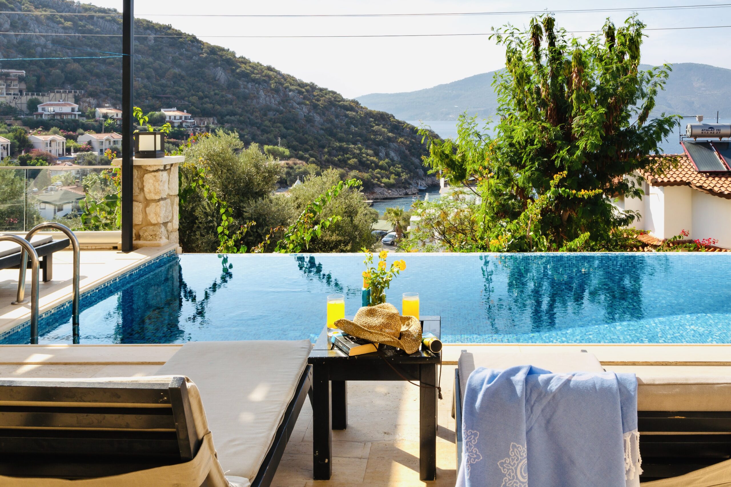 Outdoor infinity pool and sun loungers at Villa Kisla Falls, villas to rent in Kalkan, Turkey