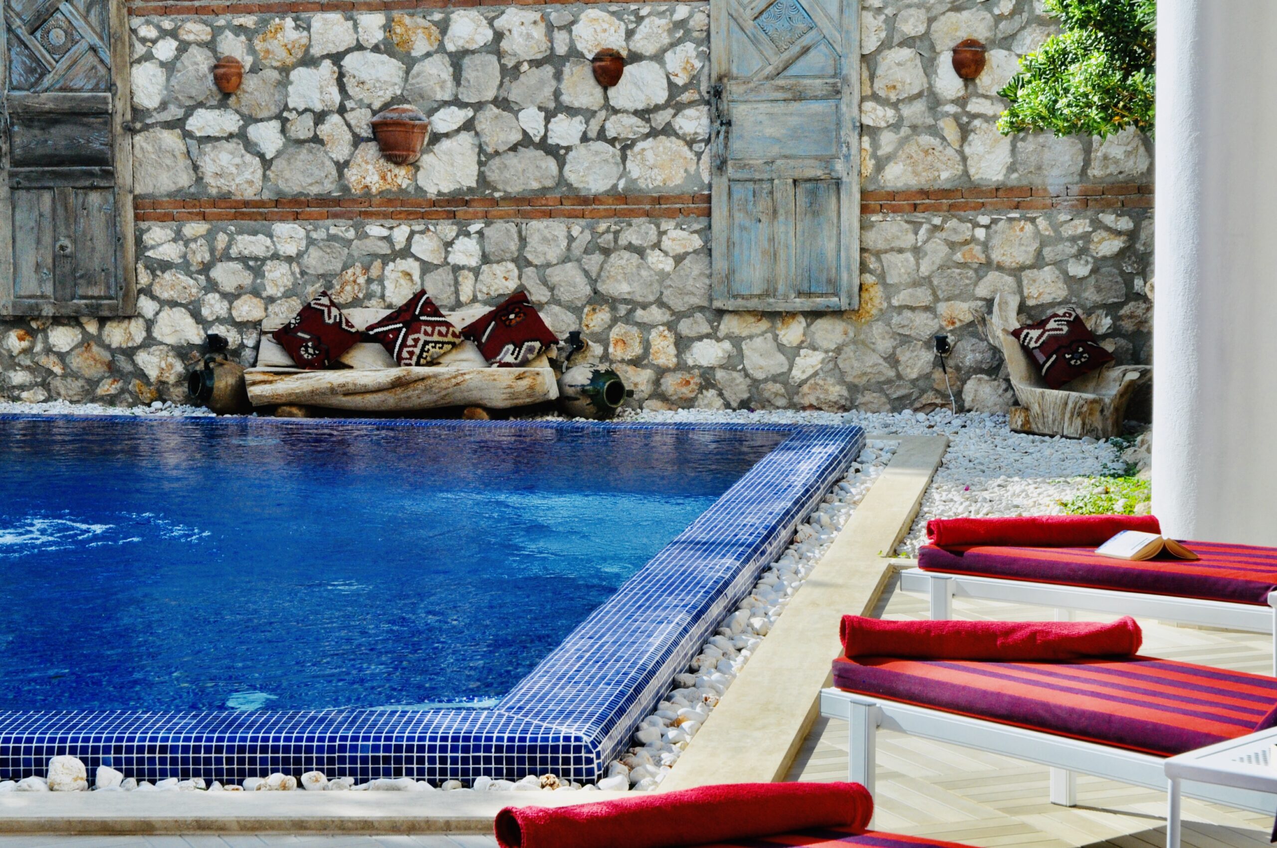 Outdoor pool and sun loungers at Villa Kirmizi Lale, holiday villas in Kalkan, Turkey