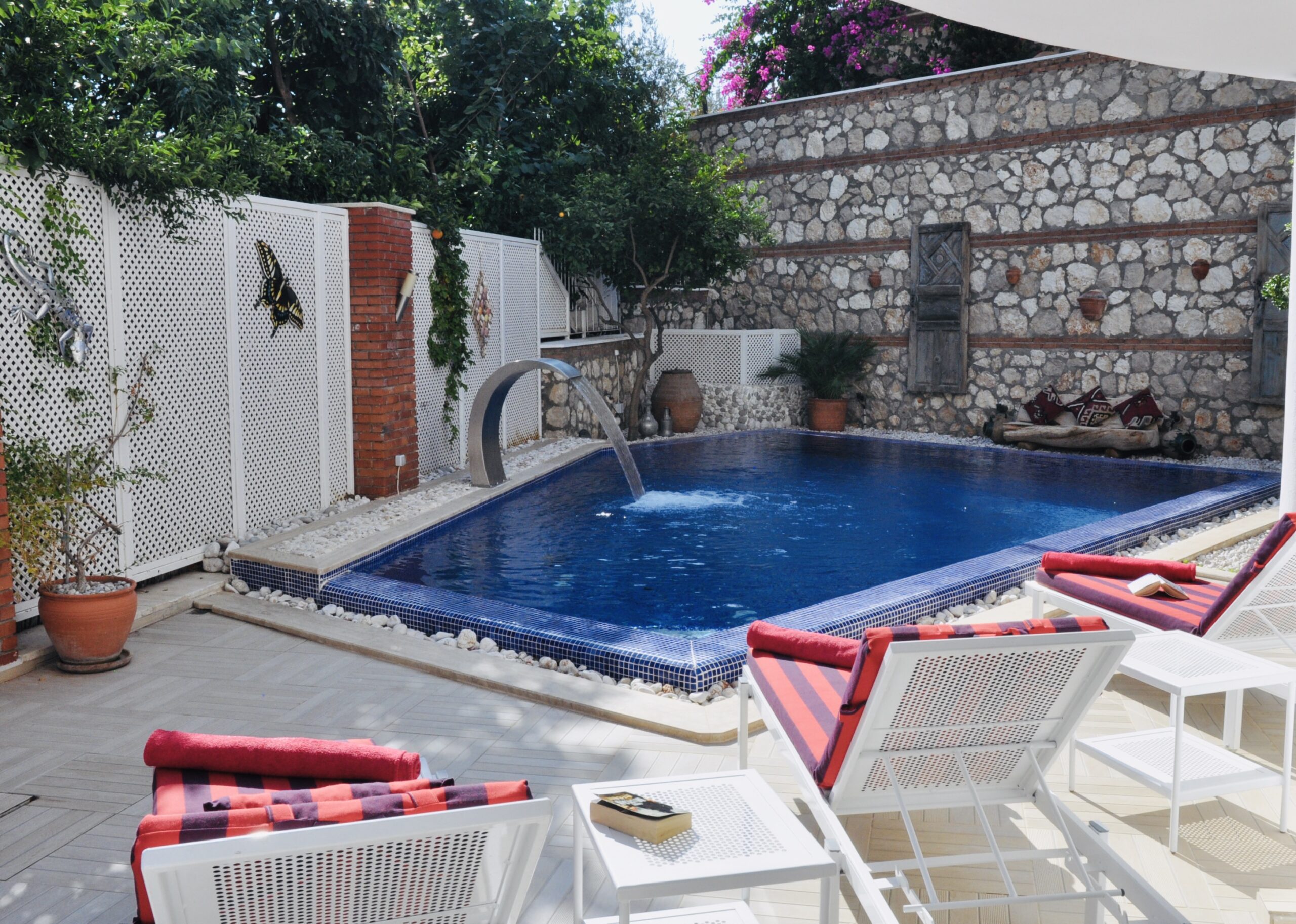 Outdoor pool and sun loungers in Villa Kirmizi Lale, holiday villas in Kalkan, Turkey