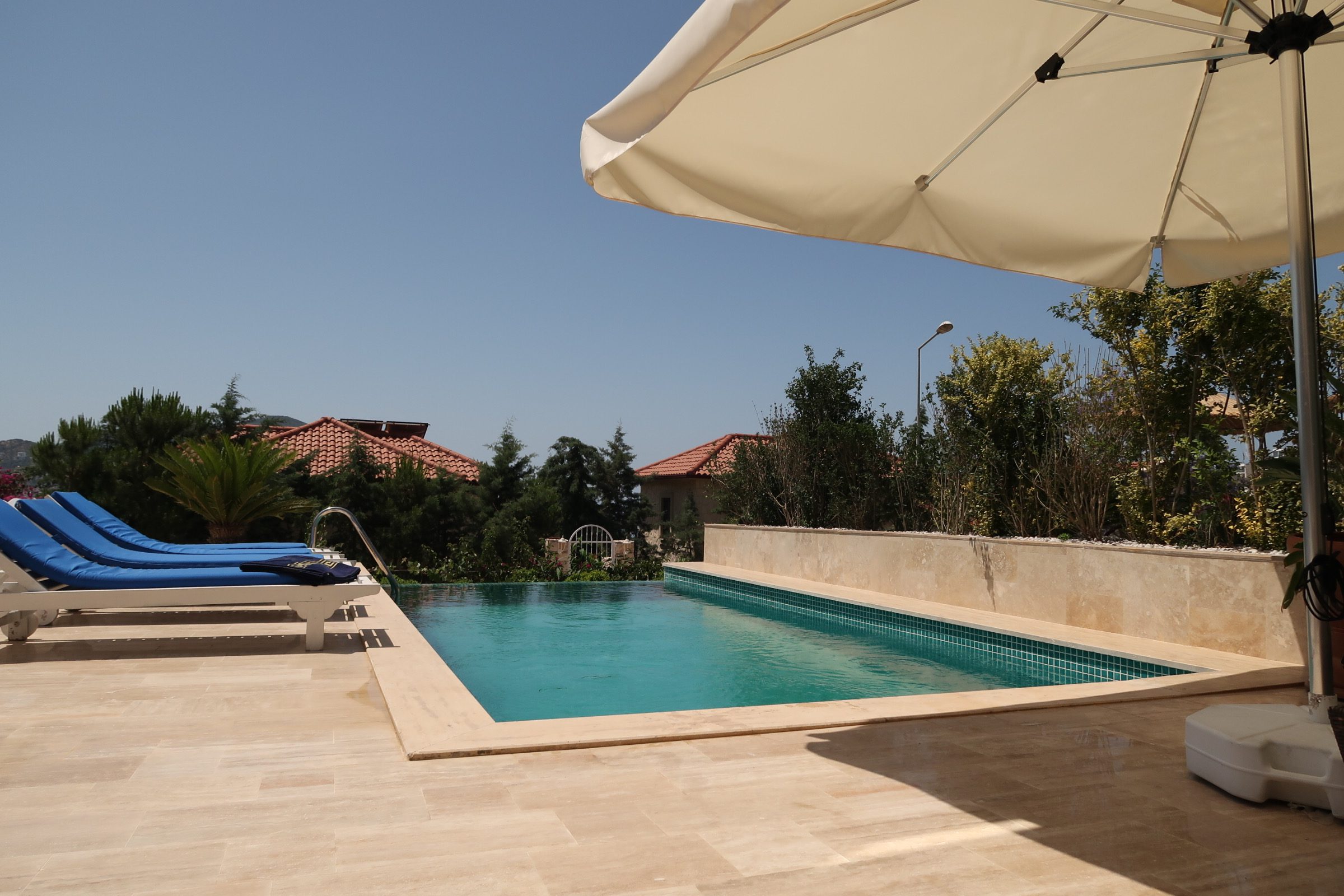 Outdoor pool with sun loungers in Villa Calypso, villa holidays in Kalkan, Turkey