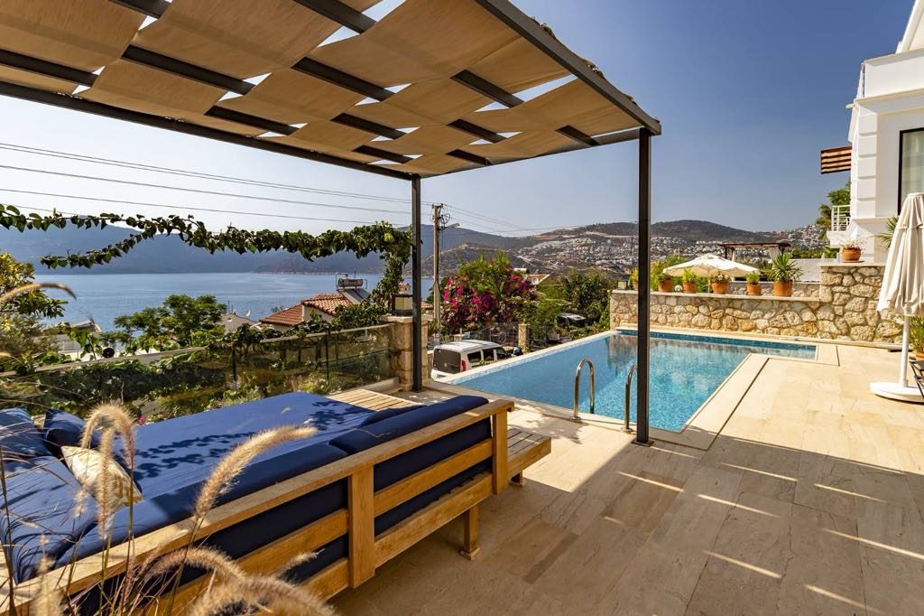 Outdoor infinity pool and sun beds at Villa Kisla Falls, villas to rent in Kalkan, Turkey
