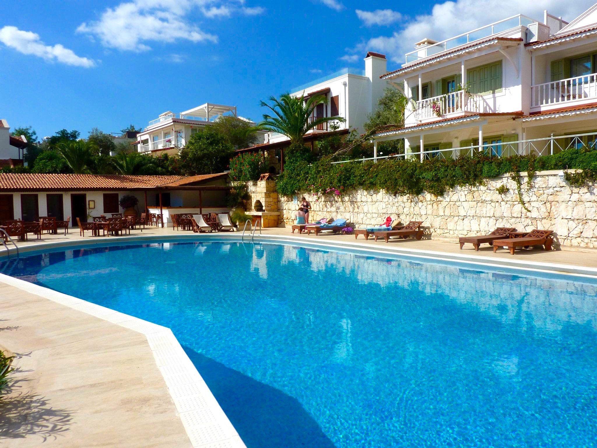 Communal outdoor pool with bar and sun loungers in Villa Amelia, villas to rent in Kalkan, Turkey