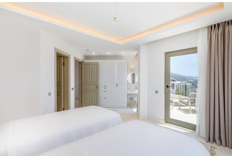 Twin bedroom and balcony in Villa Bahce, villas to rent in Kalkan, Turkey